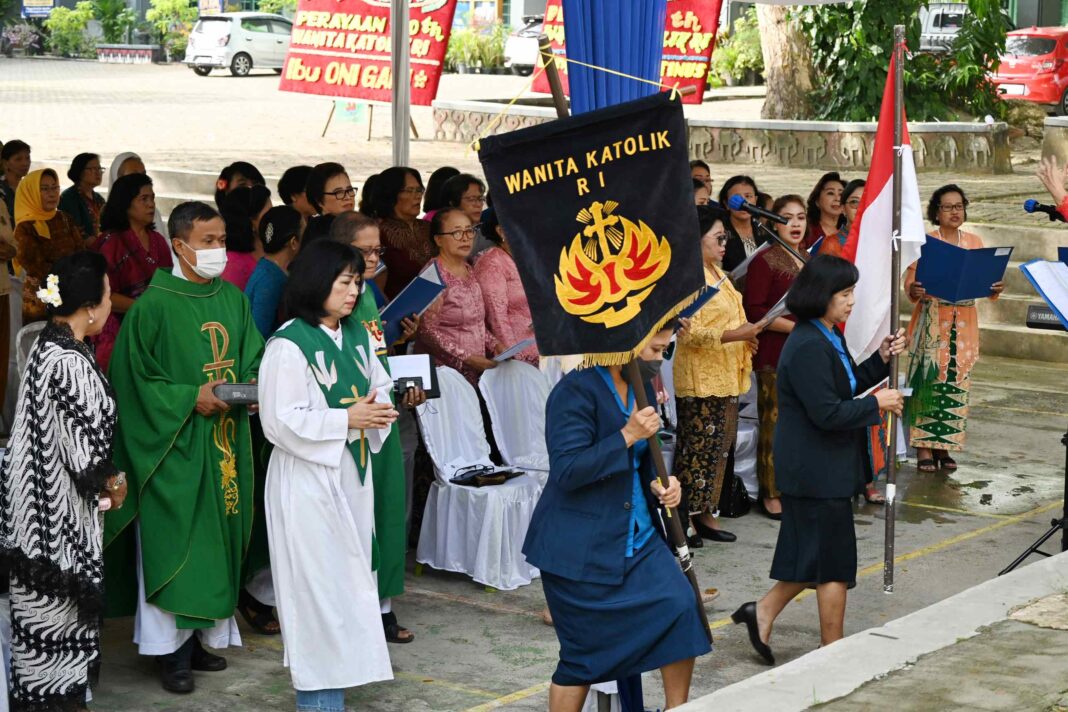 Perarakan dua vandel Merah Putih dan WKRI beserta dua pastor menuju altar.